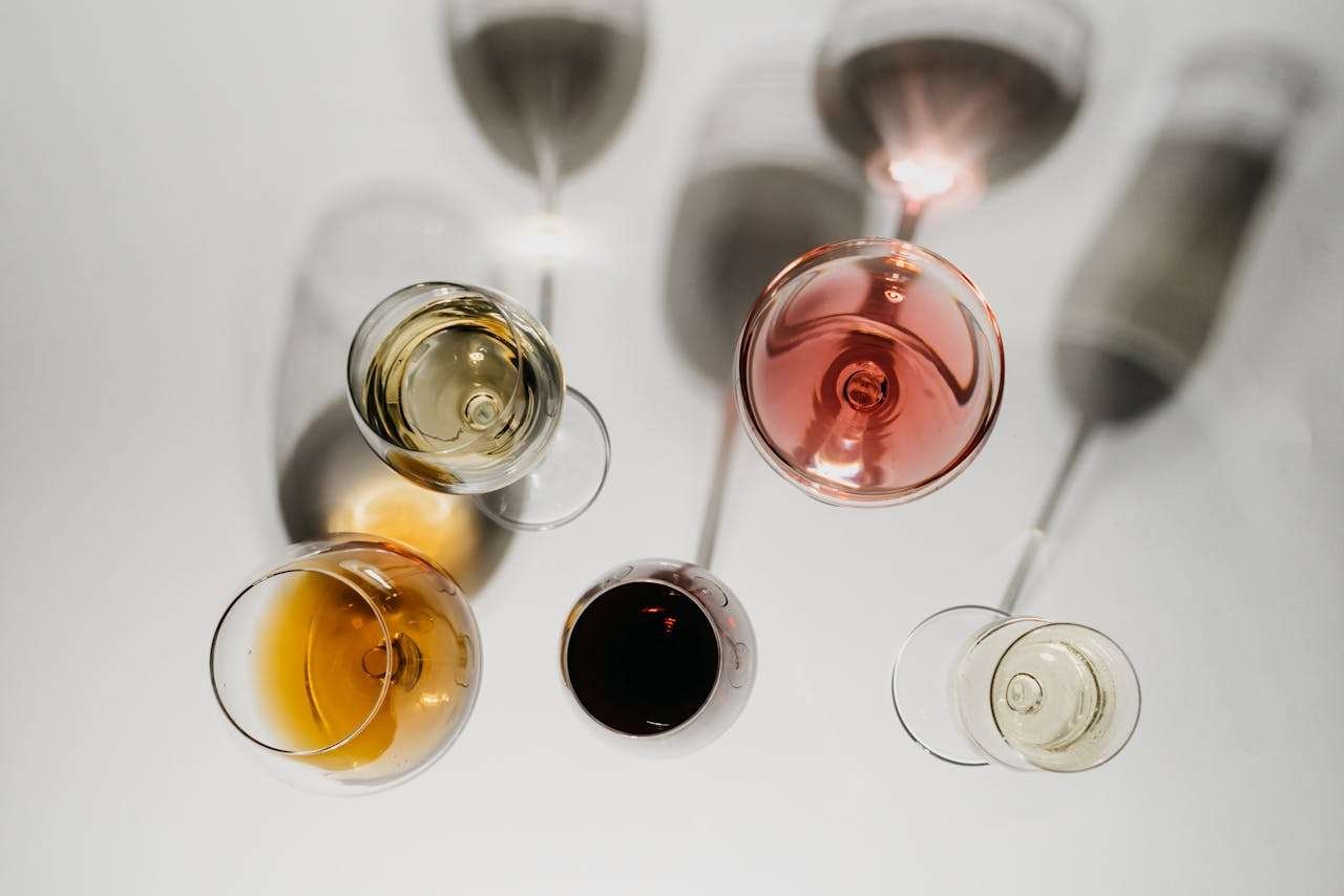 Overhead Shot of Alcoholic Drinks on a White Surface