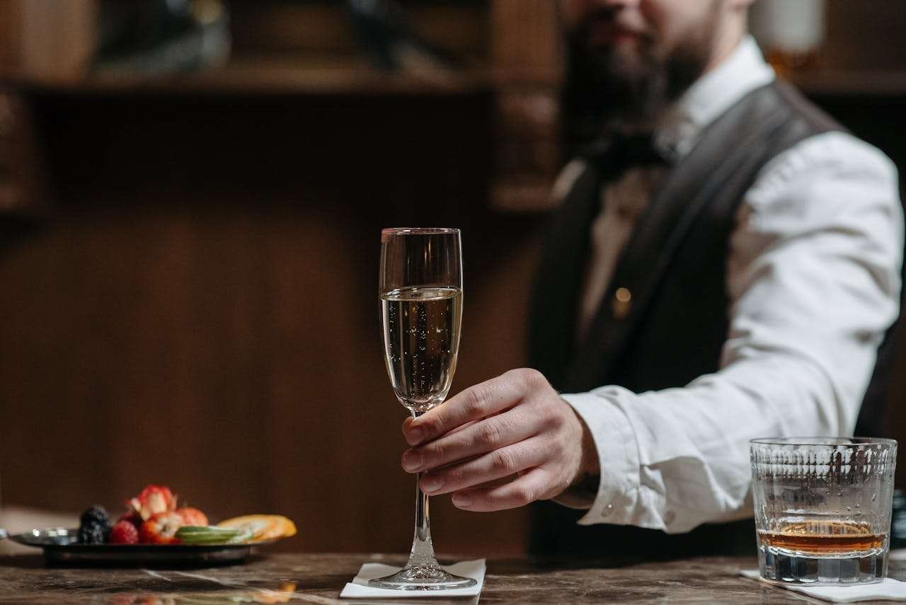 A Bartender Serving a Glass of Wine